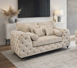 Beige tufted sofa in a living room setting with a TV and decorative items 2 Seater Cream